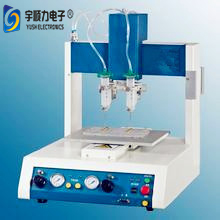 Close-up of glue dispensing head in operation