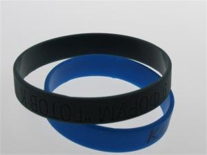 China solid color black custom debossed silicone bracelets on sale